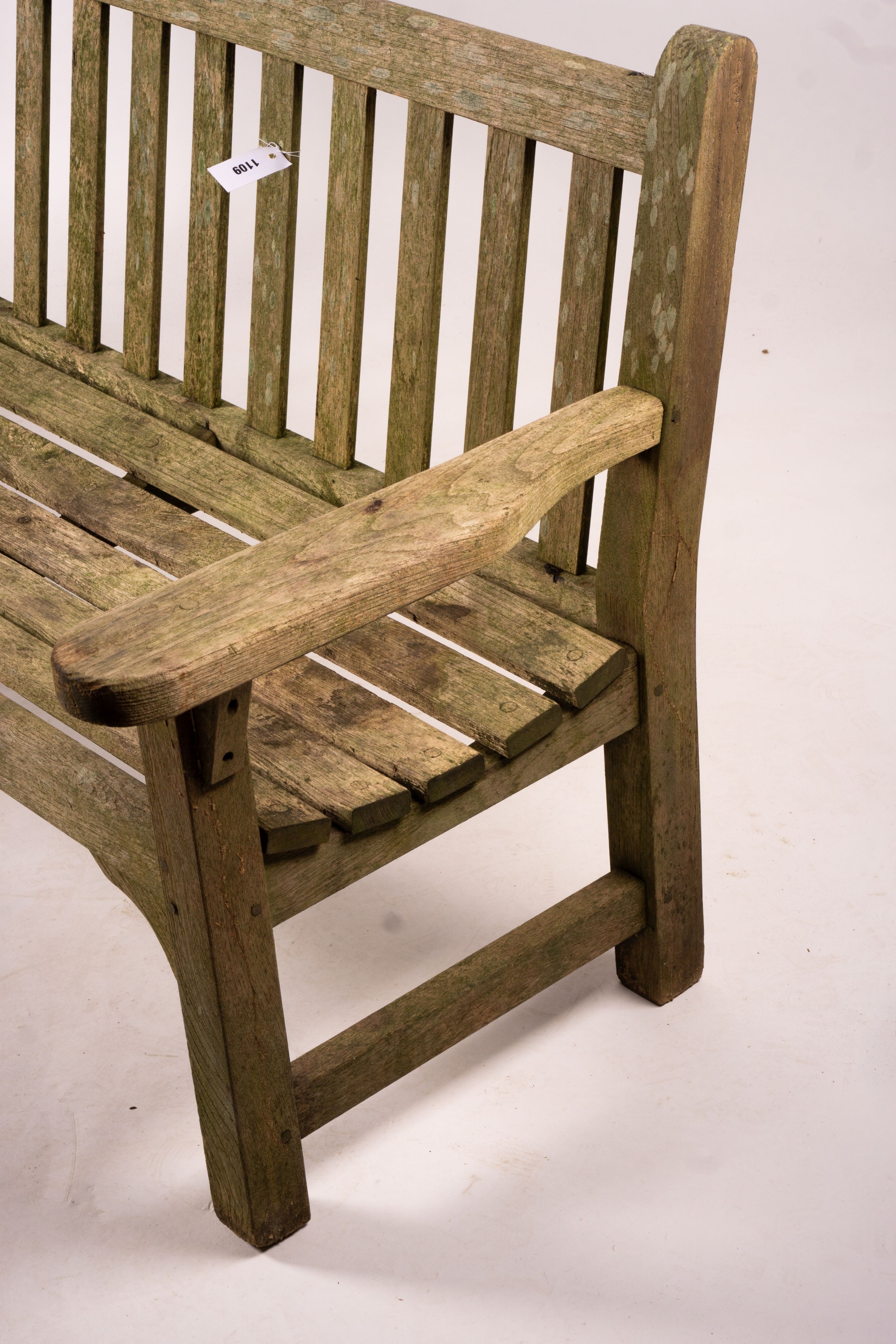 A weathered teak garden bench, length 192cm, width 60cm, height 85cm